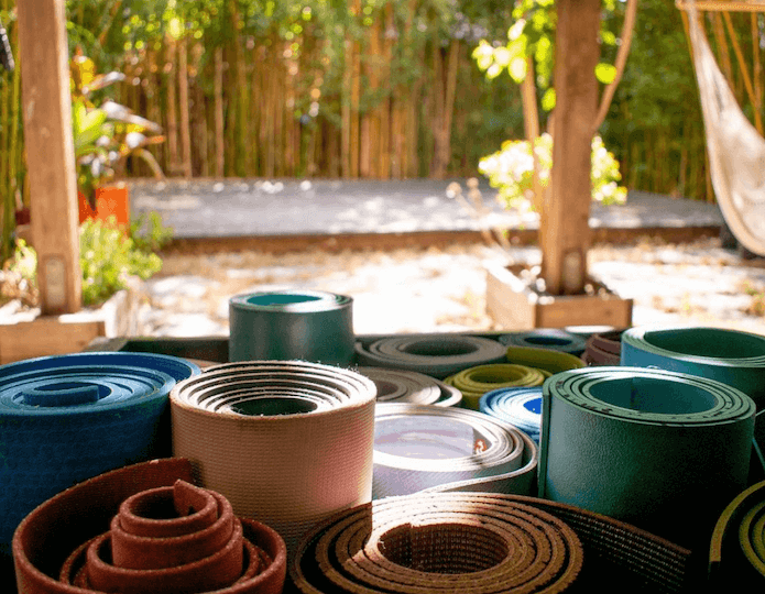 Rolled yoga mats in the studio garden