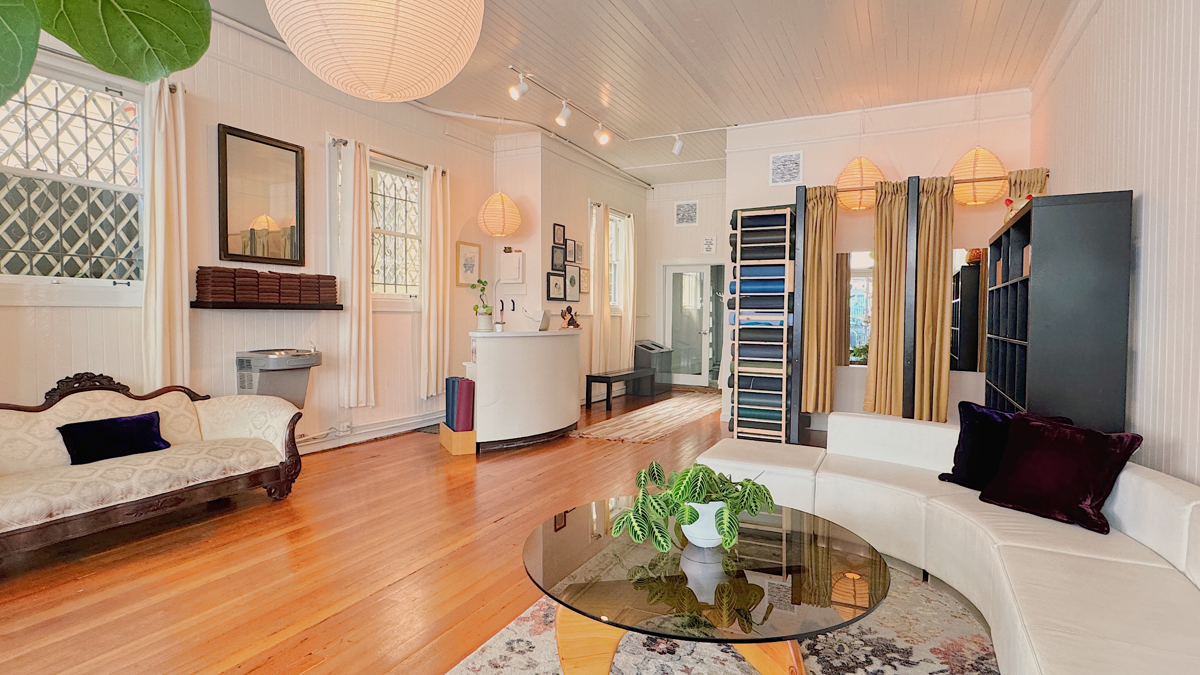 The AstaYoga lounge, a living room with sofas at the front of the studio