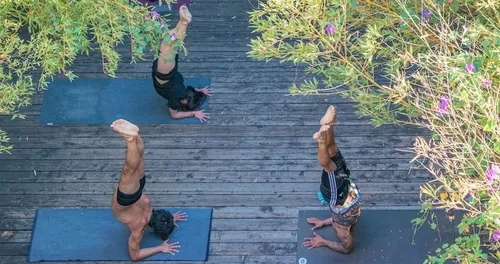 Three students practicing on the studio’s backyard deck
